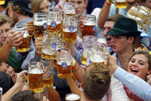 People celebrate the opening of the 182. Oktoberfest beer festival in Munich, southern Germany, Saturday, Sept. 19, 2015. The world's largest beer festival will be held from Sept. 19 to Oct. 4, 2015. (AP Photo/Matthias Schrader)